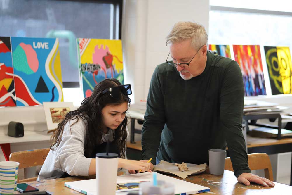 teacher and student in art studio