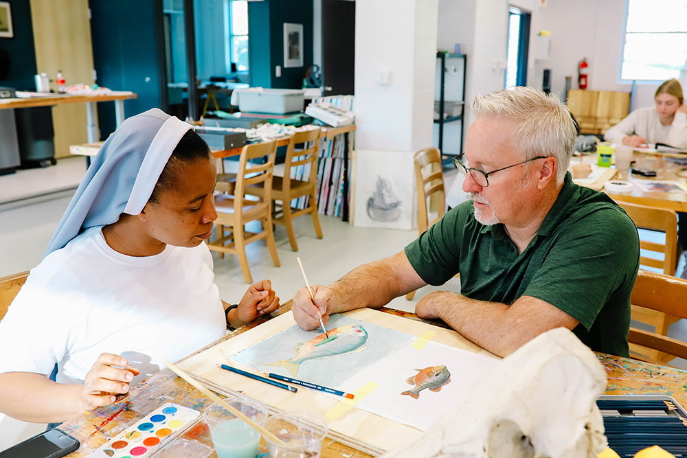 teacher and student painting with watercolors
