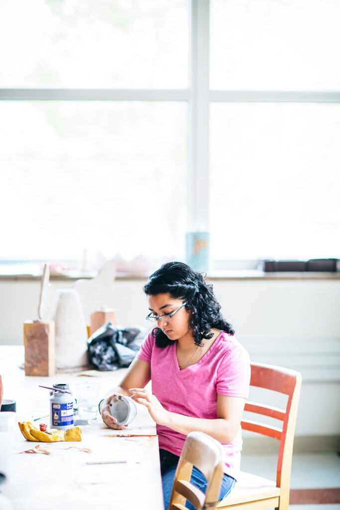student working on sculpture art
