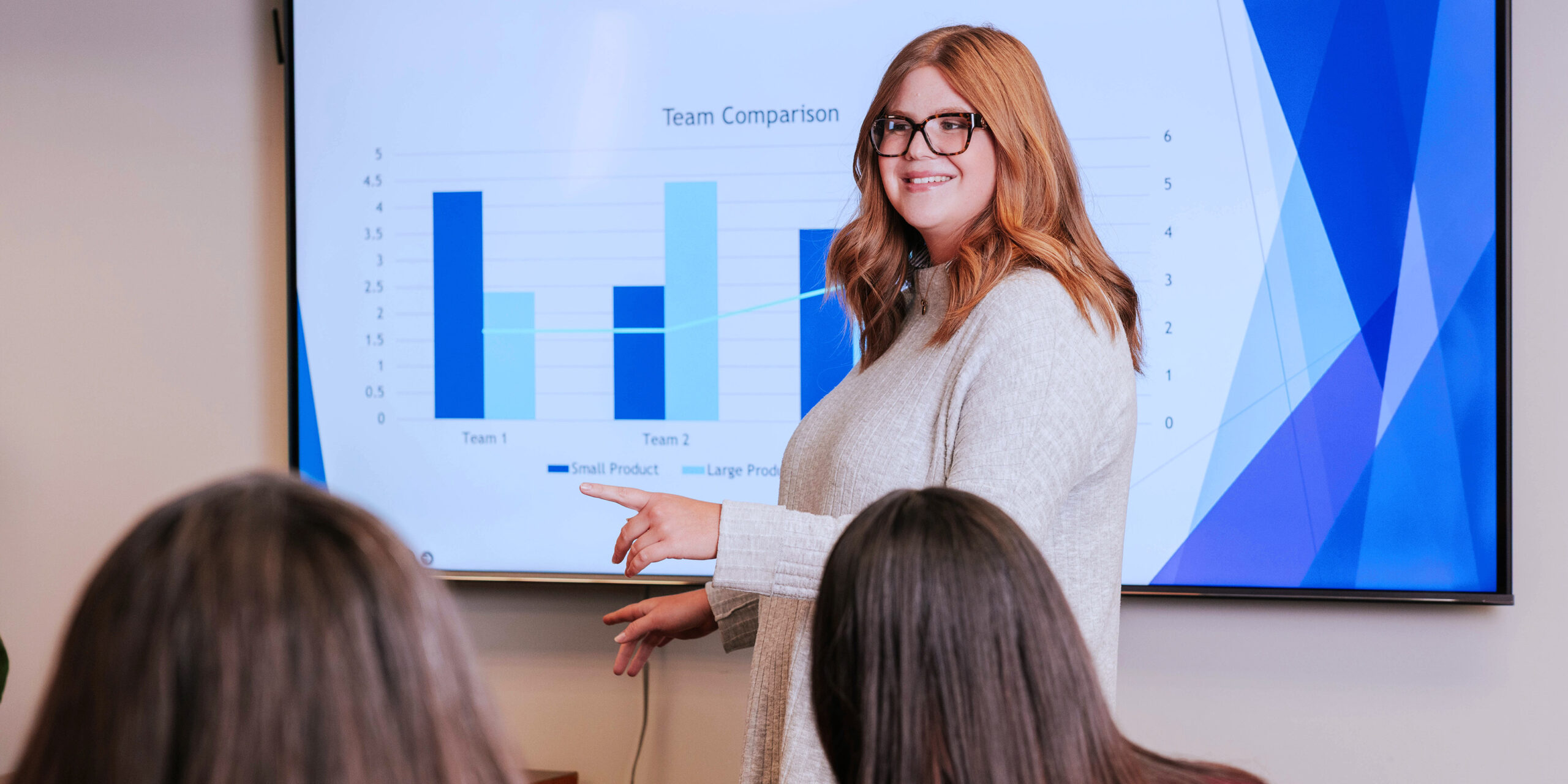 A woman gives a presentation in a board room.