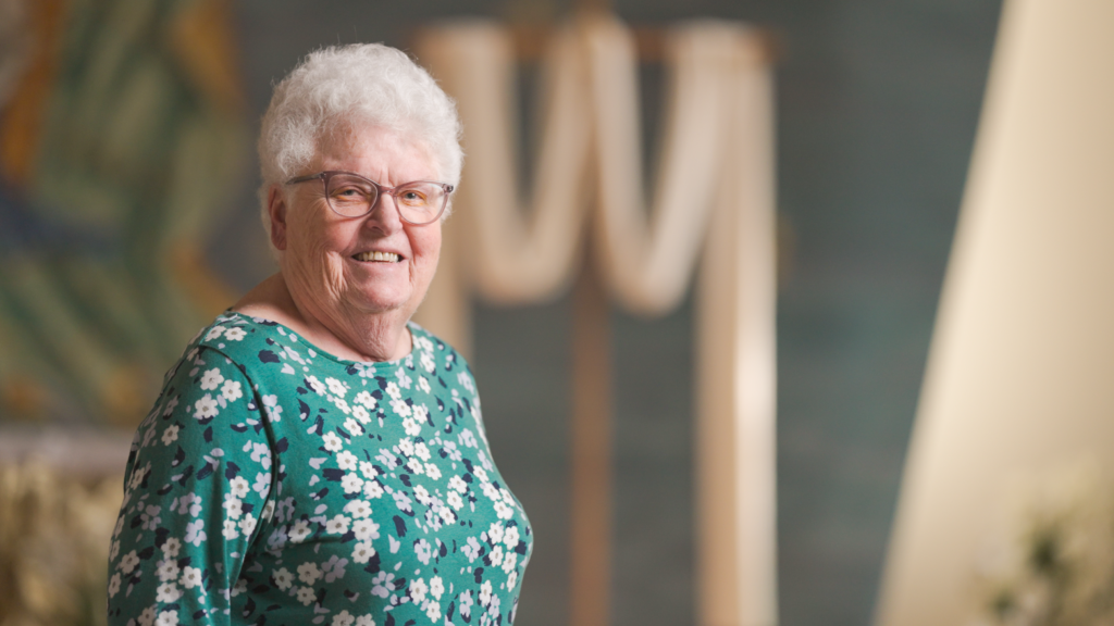 woman smiling at camera in a chapel