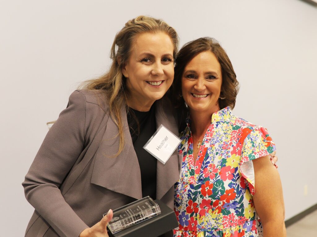 two women smiling at camera