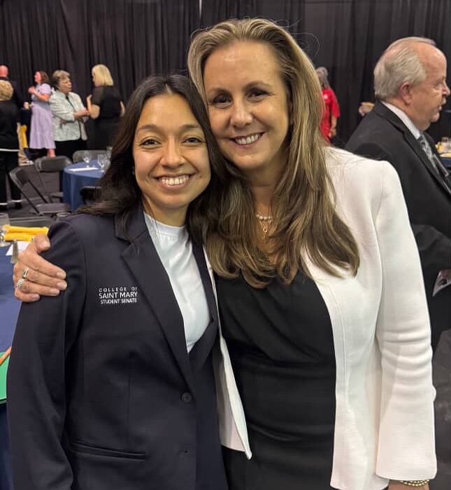 two women smiling at camera